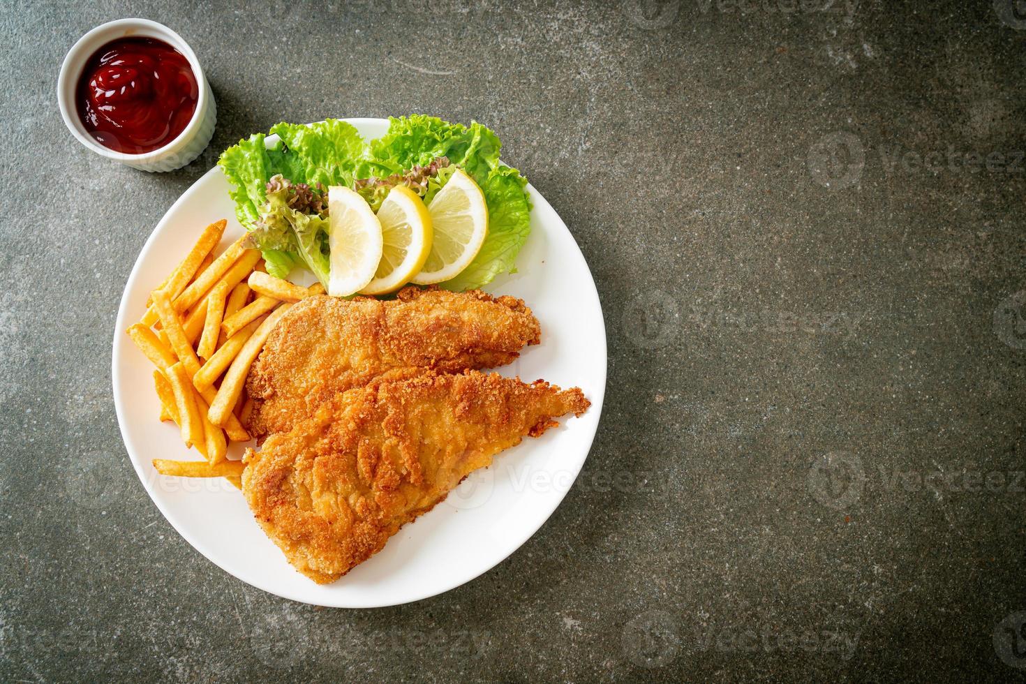 Homemade Breaded Weiner Schnitzel with Potato Chips photo