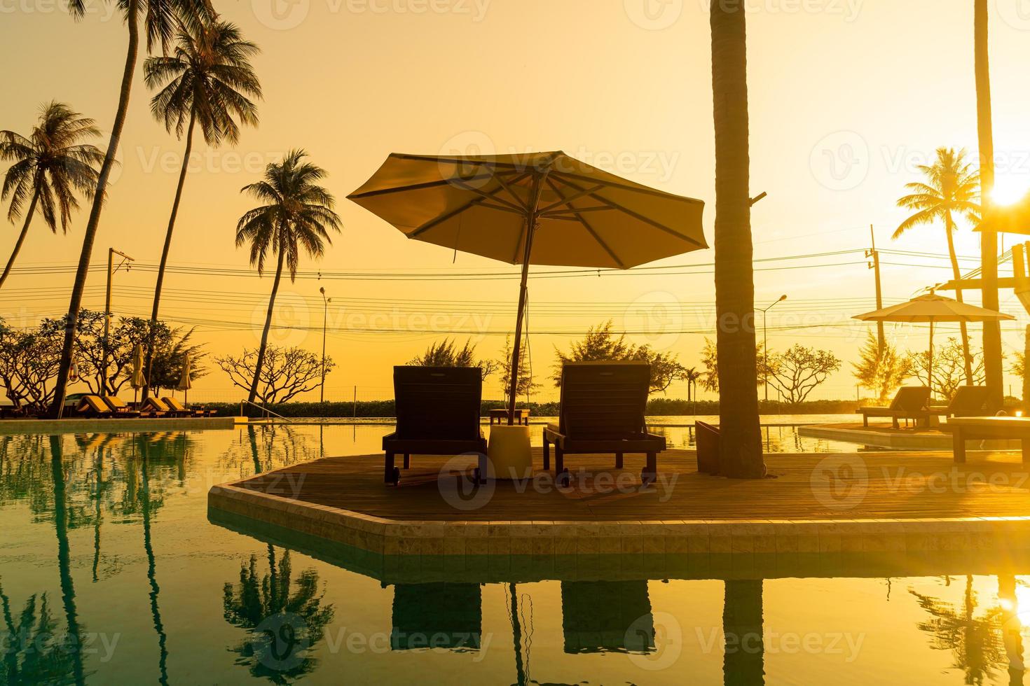 umbrella with bed pool around swimming pool with ocean sea background