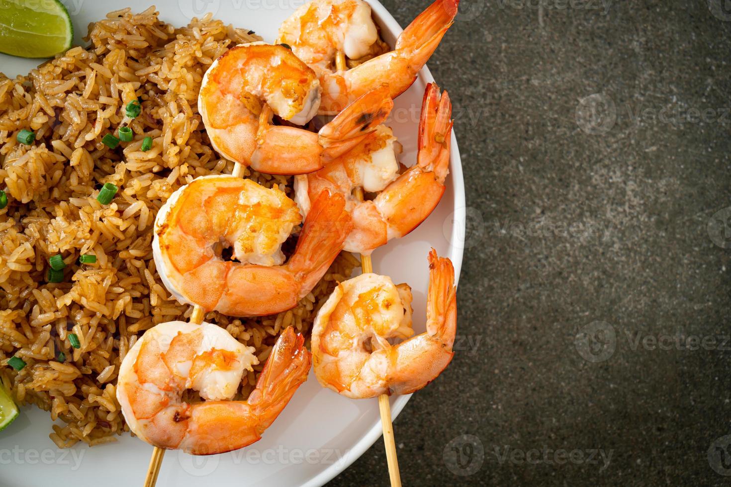fried rice with shrimps skewers photo