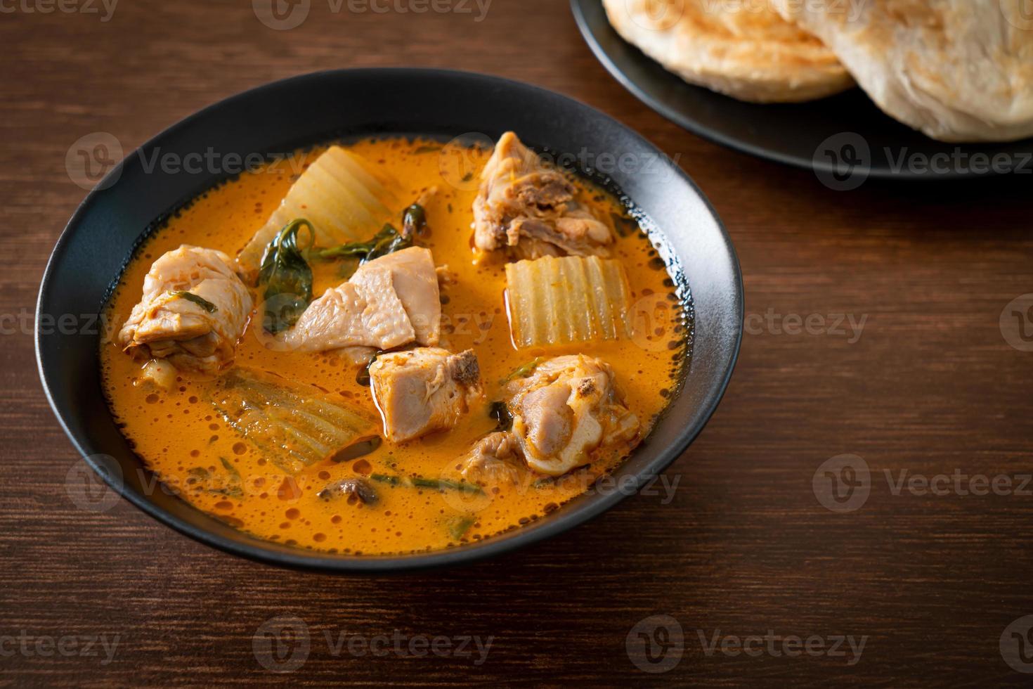 Chicken curry soup with roti photo