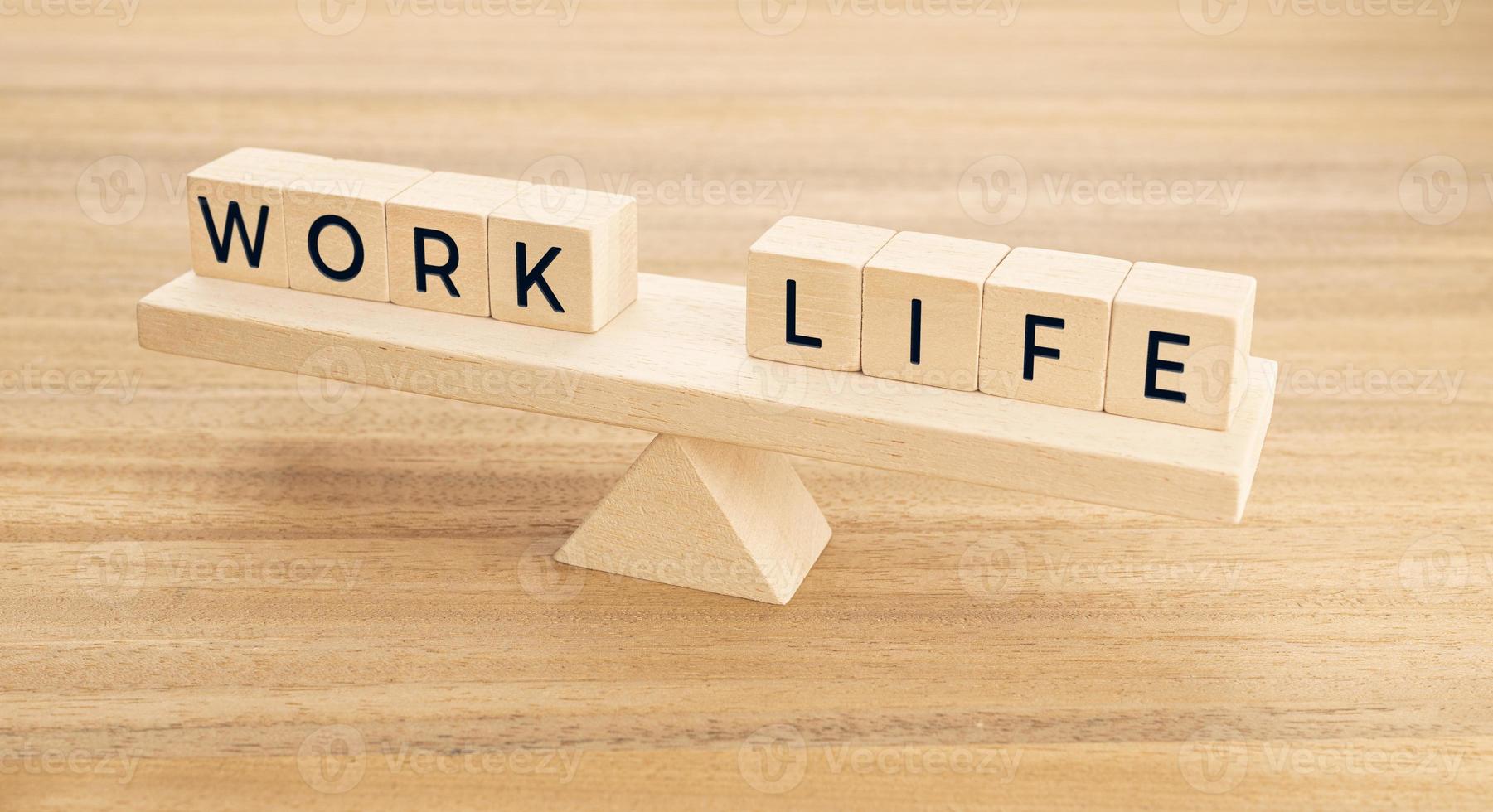 Work and Life balance concept. Wooden blocks with text on Seesaw photo