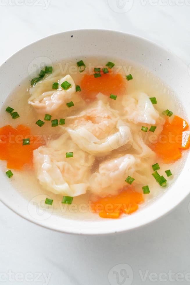 shrimp dumpling soup in white bowl photo