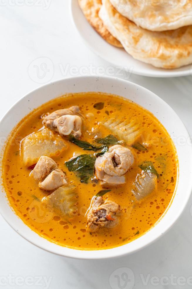 Chicken curry soup with roti photo