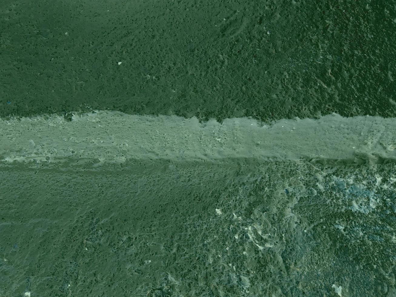 Dark green background. Artificial image of pouring plaster for background work. photo