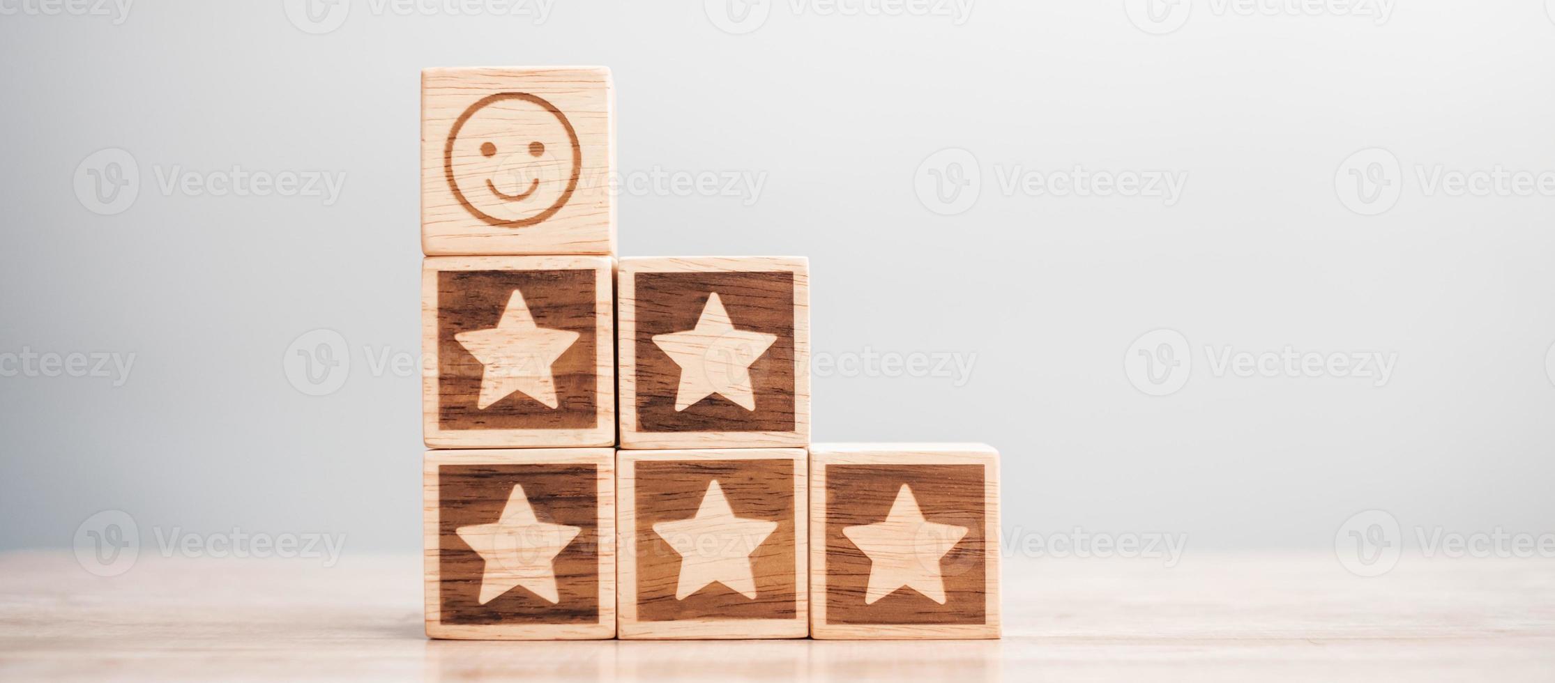 emotion face and Star symbol blocks on table background. Service rating, ranking, customer review, satisfaction, evaluation and feedback concept photo