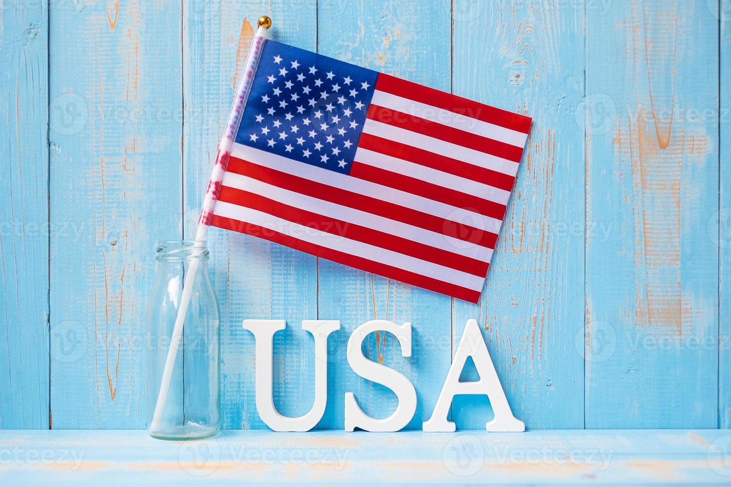 USA text and United States of America flag on wooden table background. concept of Veterans, Memorial, Independence and Labor Day photo