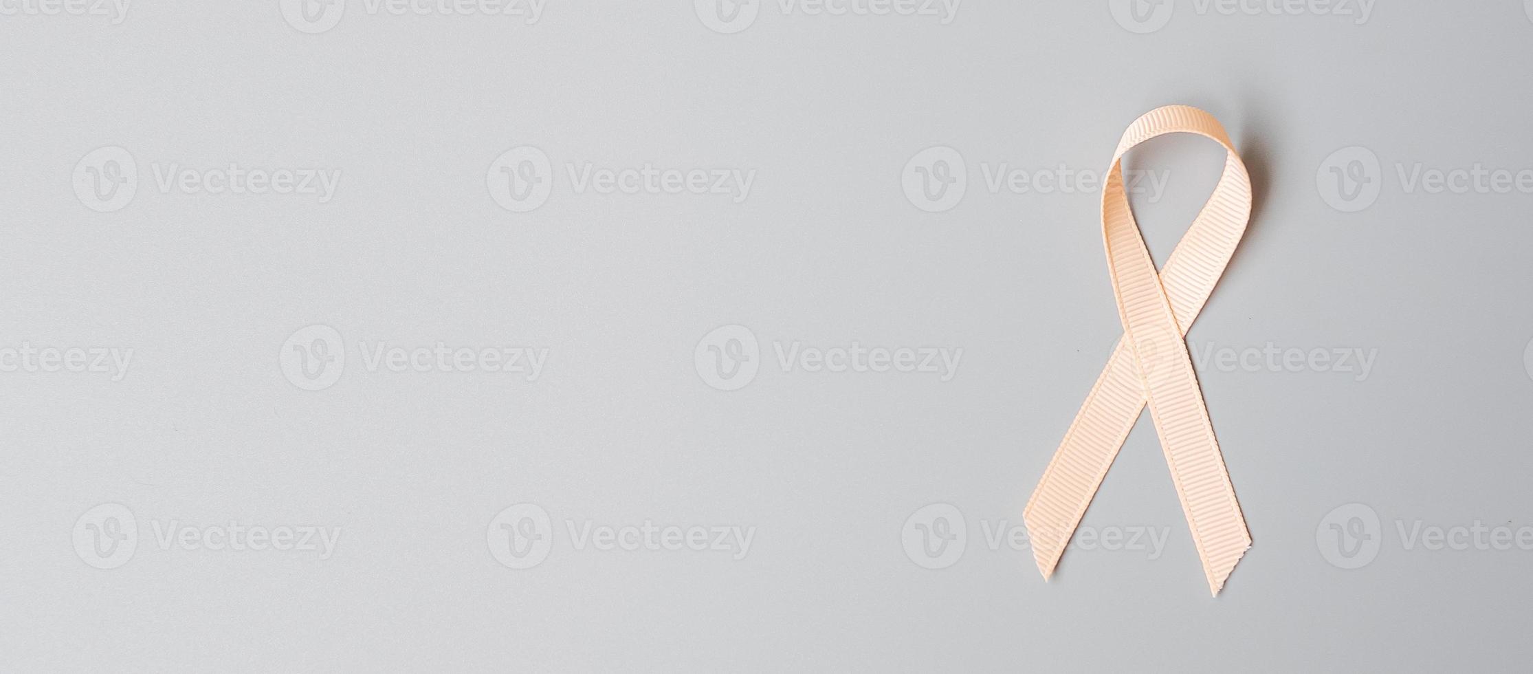 September Uterine Cancer Awareness month, Peach Ribbon for supporting people living and illness. Healthcare and World cancer day concept photo