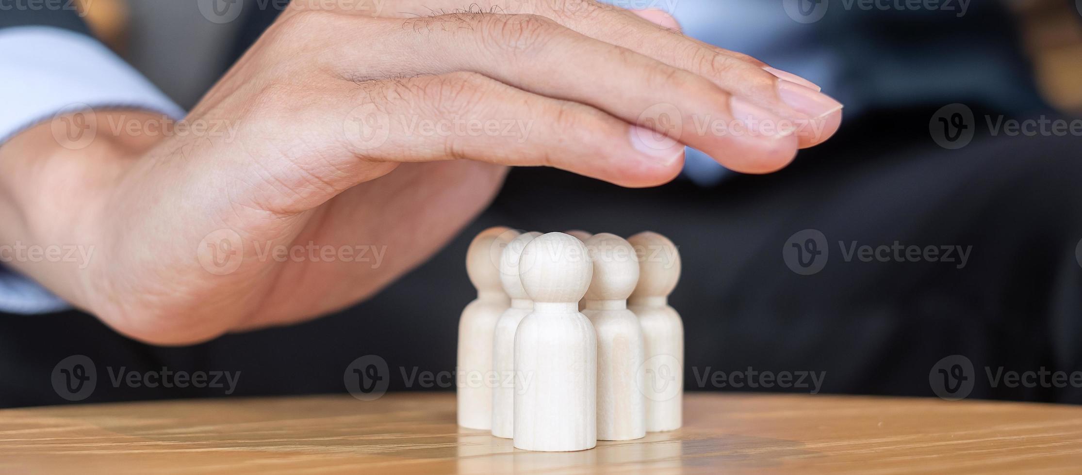 Businessman hand cover man wooden from crowd of employees. People, Business, Human resource management, Life Insurance, Teamwork and leadership Concepts photo