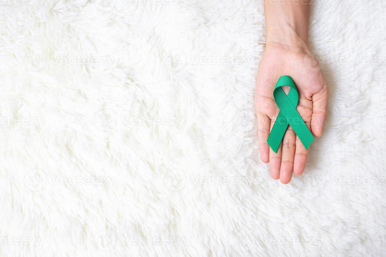 September Ovarian cancer Awareness month, Woman holding teal Ribbon color for supporting people living, and illness. Healthcare and world cancer day concepts photo