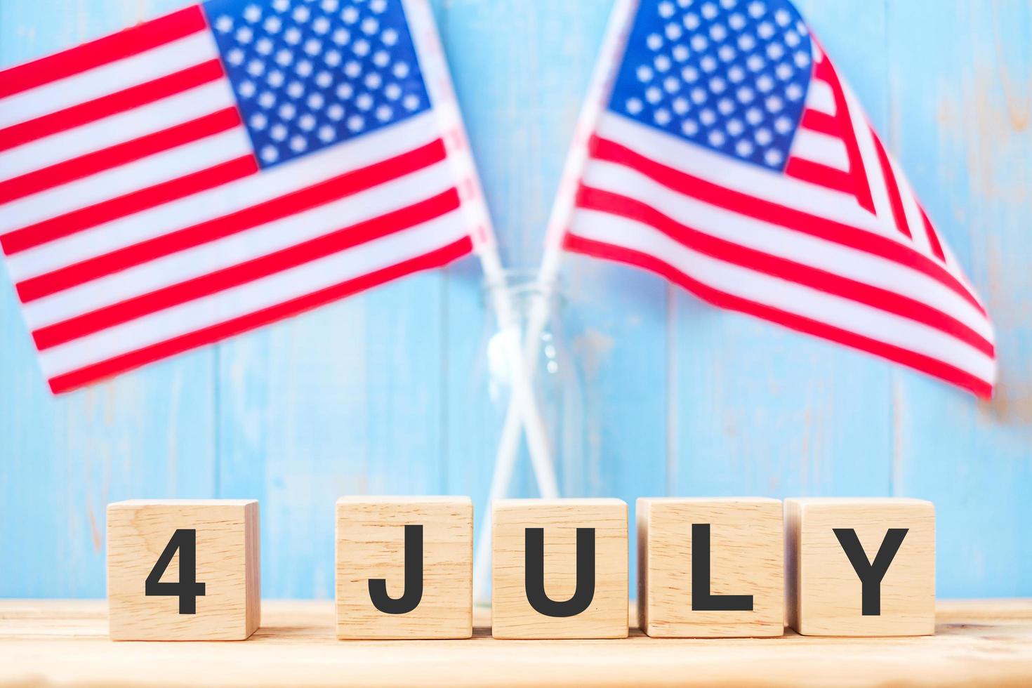 Fourth of July text on United States of America flag background. USA holiday of Independence and celebration concepts photo