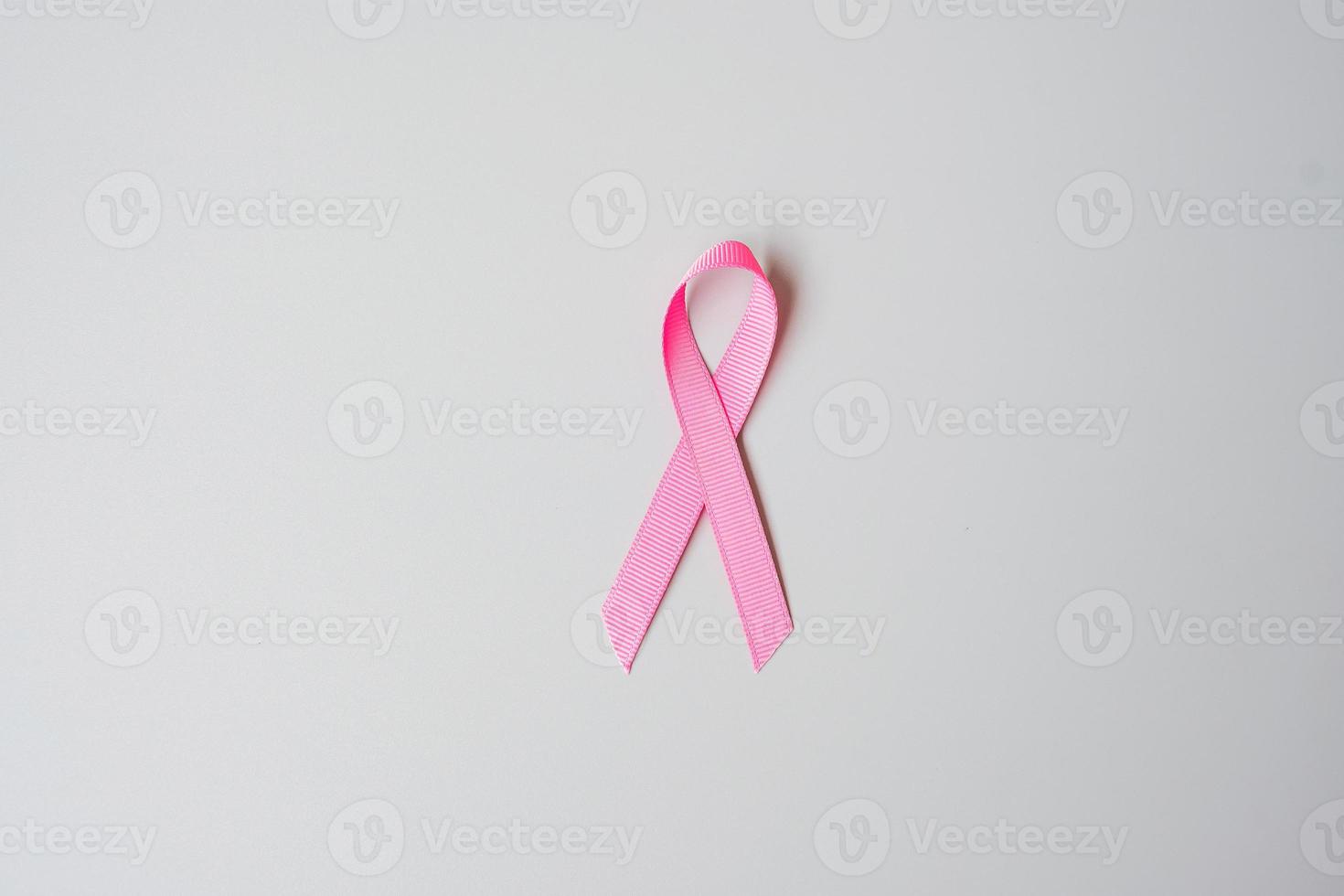 October Breast Cancer Awareness month, Pink Ribbon on grey background for supporting people living and illness. International Women, Mother and World cancer day concept photo