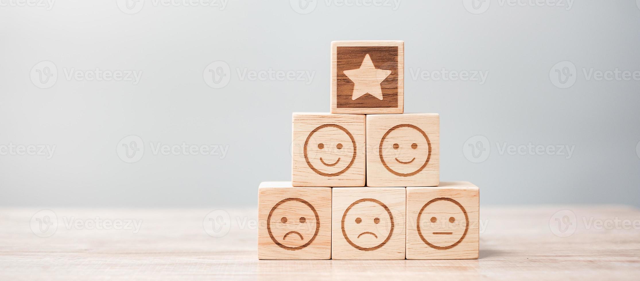 emotion face and Star symbol blocks on table background. Service rating, ranking, customer review, satisfaction, evaluation and feedback concept photo