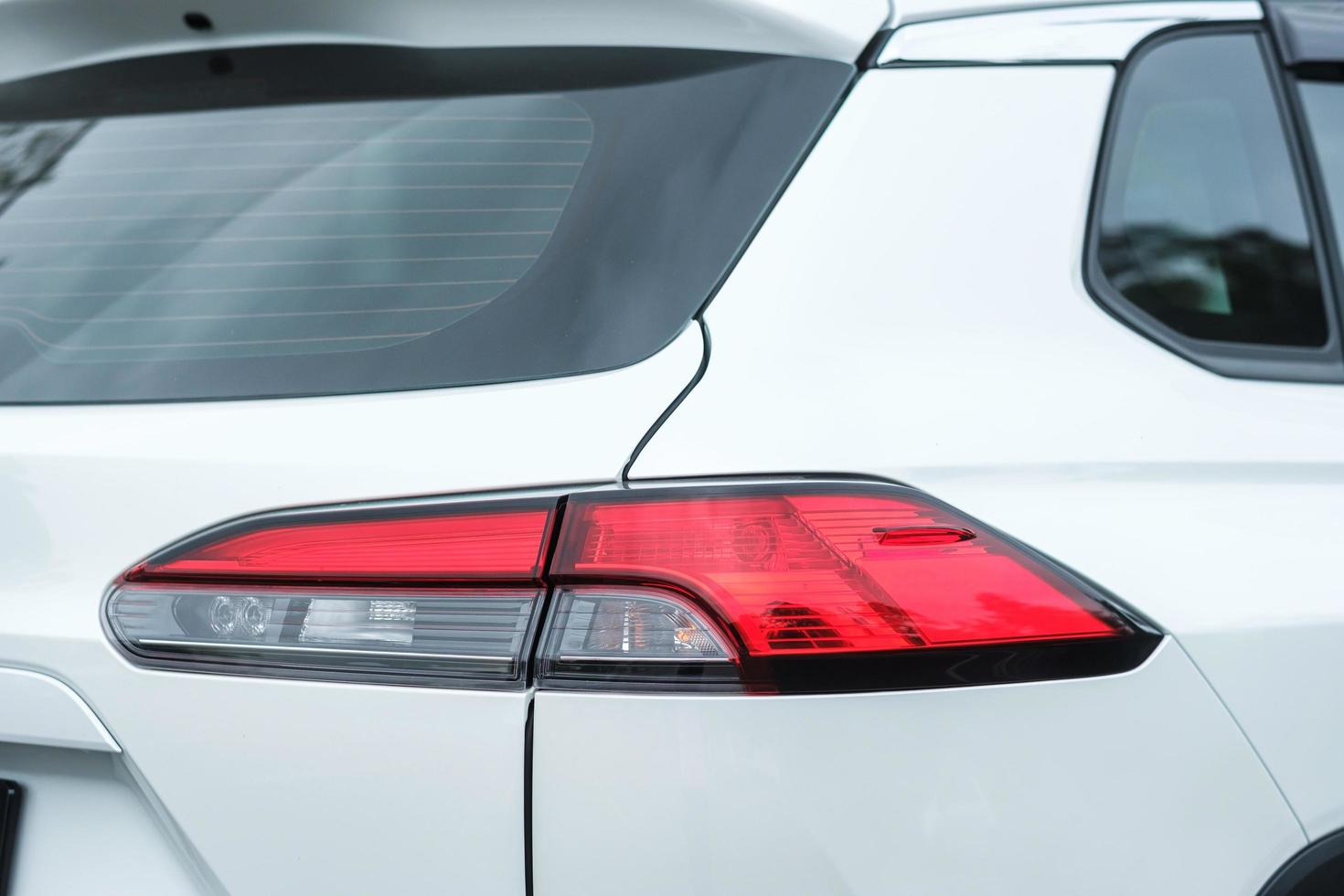 Back view part of white car with light photo