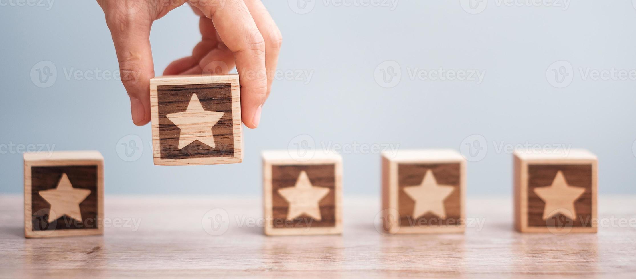 Man hand holding Star block. Customer choose rating for user reviews. Service rating, ranking, customer review, satisfaction, evaluation and feedback concept photo