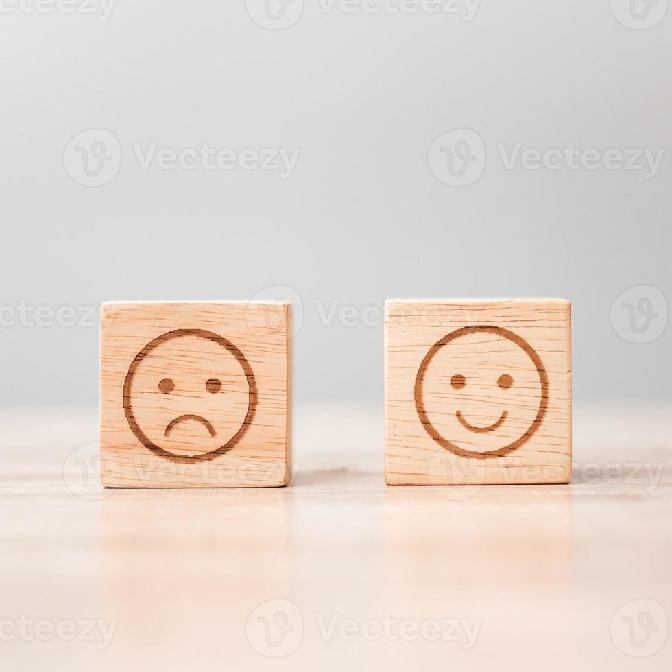 emotion face symbol on wooden blocks. Service rating, ranking, customer review, satisfaction, evaluation and feedback concept photo