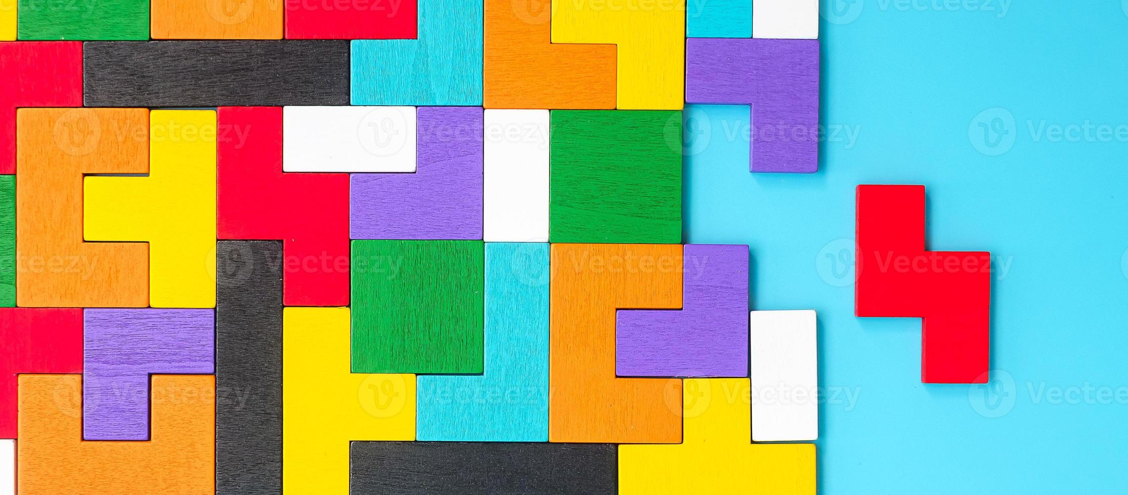 colorful wood puzzle pieces on blue background, geometric shape block. Concepts of logical thinking, Conundrum, solutions, rational, strategy, world logic day and Education photo