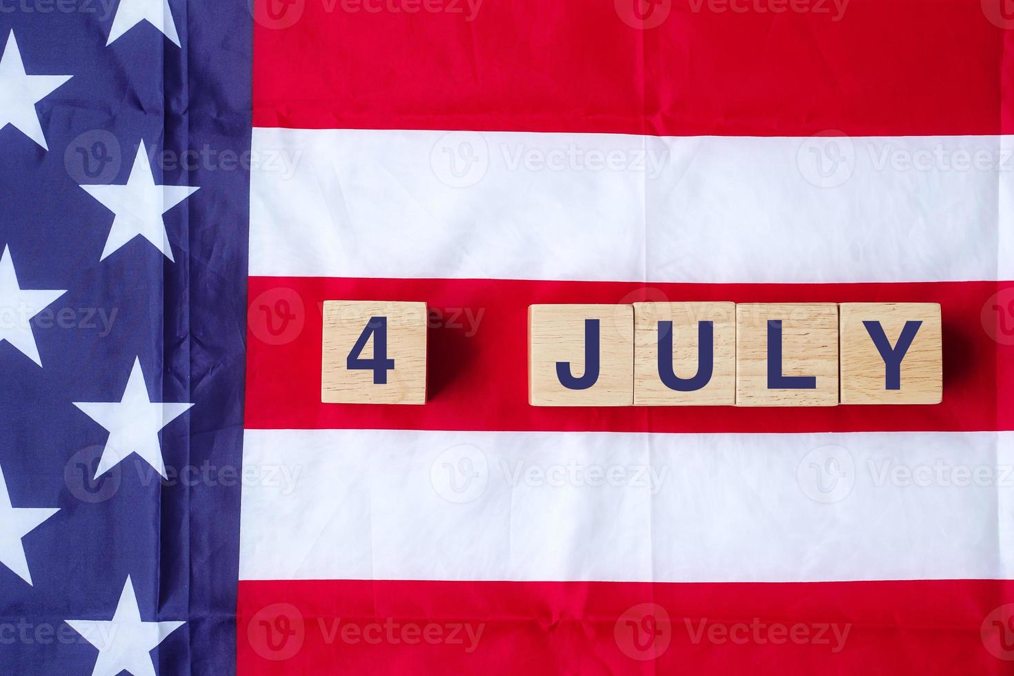 Fourth of July text on United States of America flag background. USA holiday of Independence and celebration concepts photo