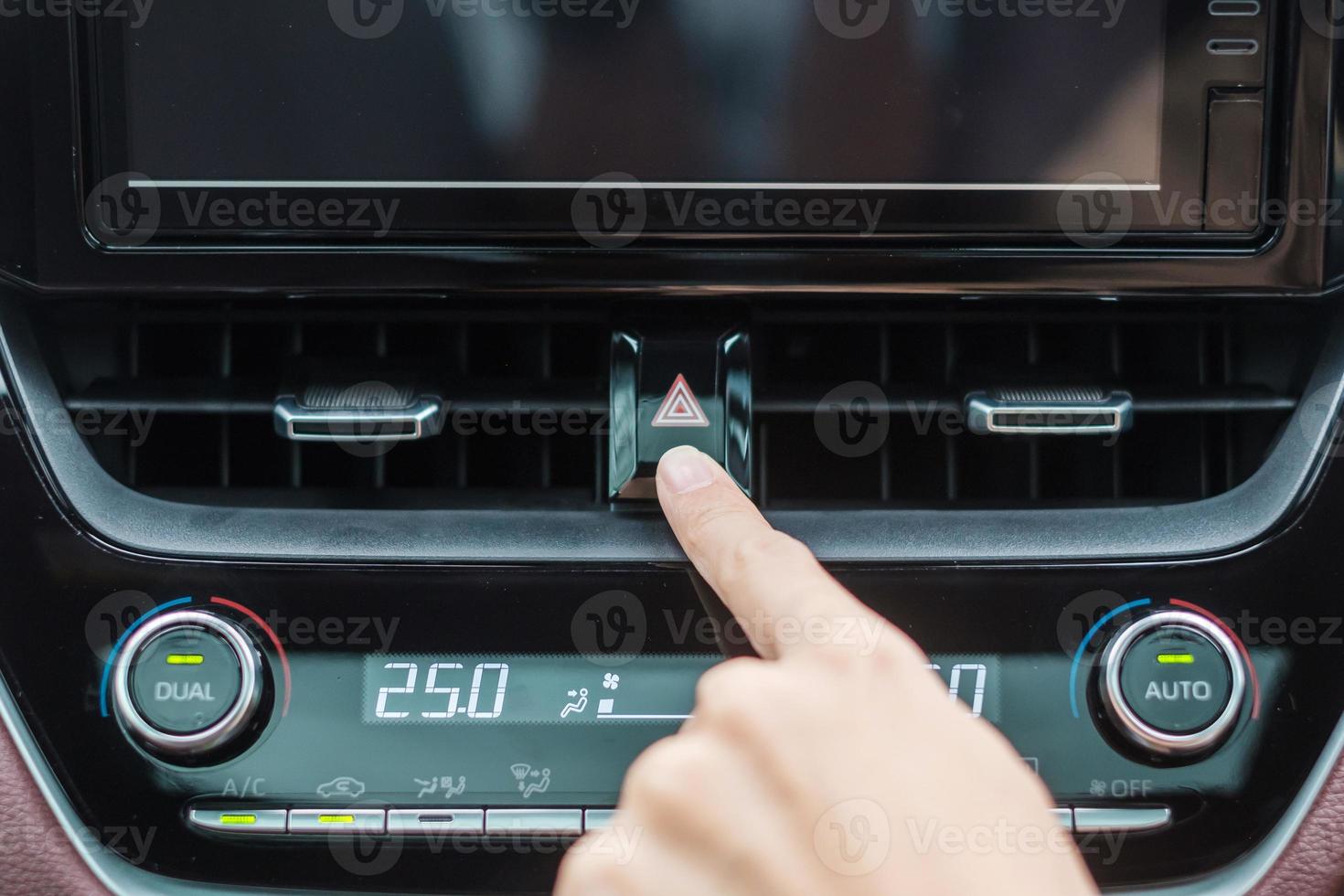 Finger presses the emergency stop button inside the car. Safety and transportation concept photo