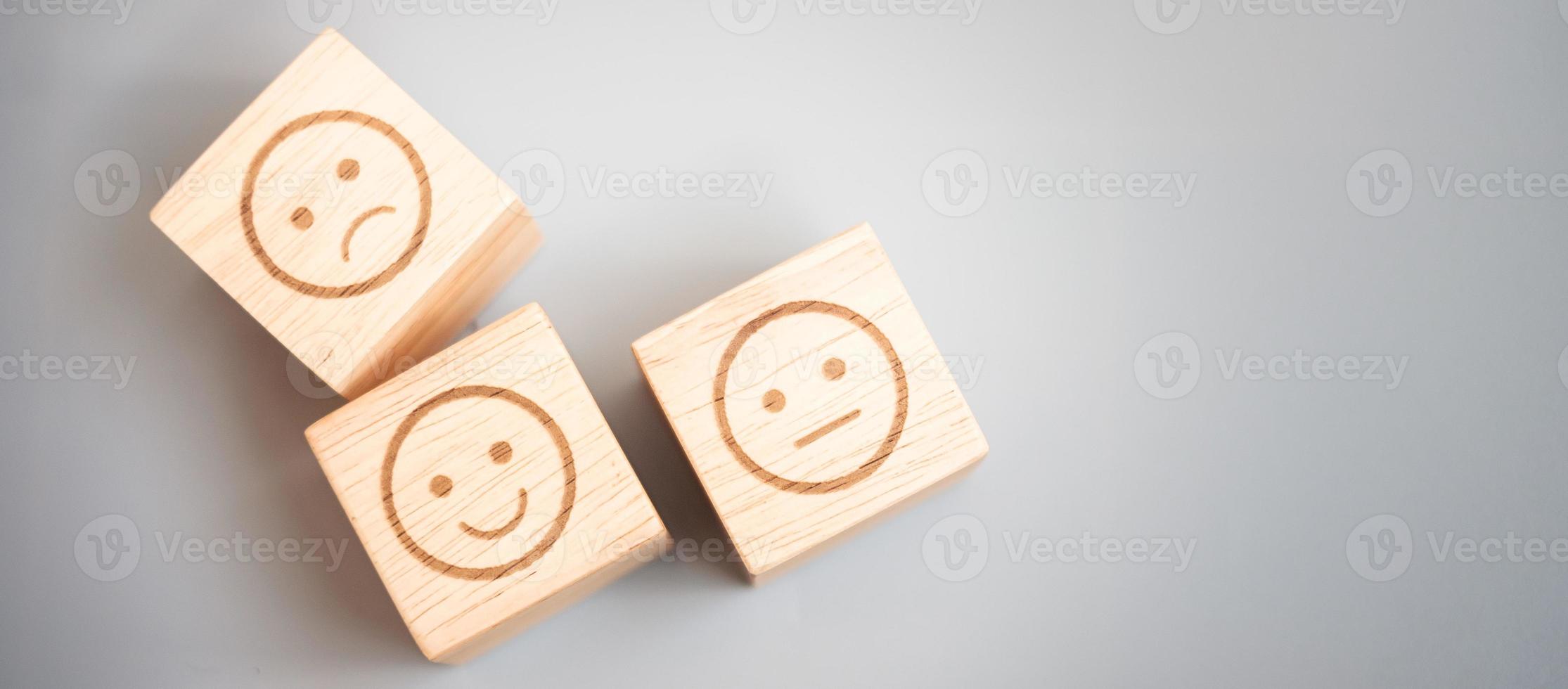 emotion face symbol on wooden blocks. Service rating, ranking, customer review, satisfaction, evaluation and feedback concept photo