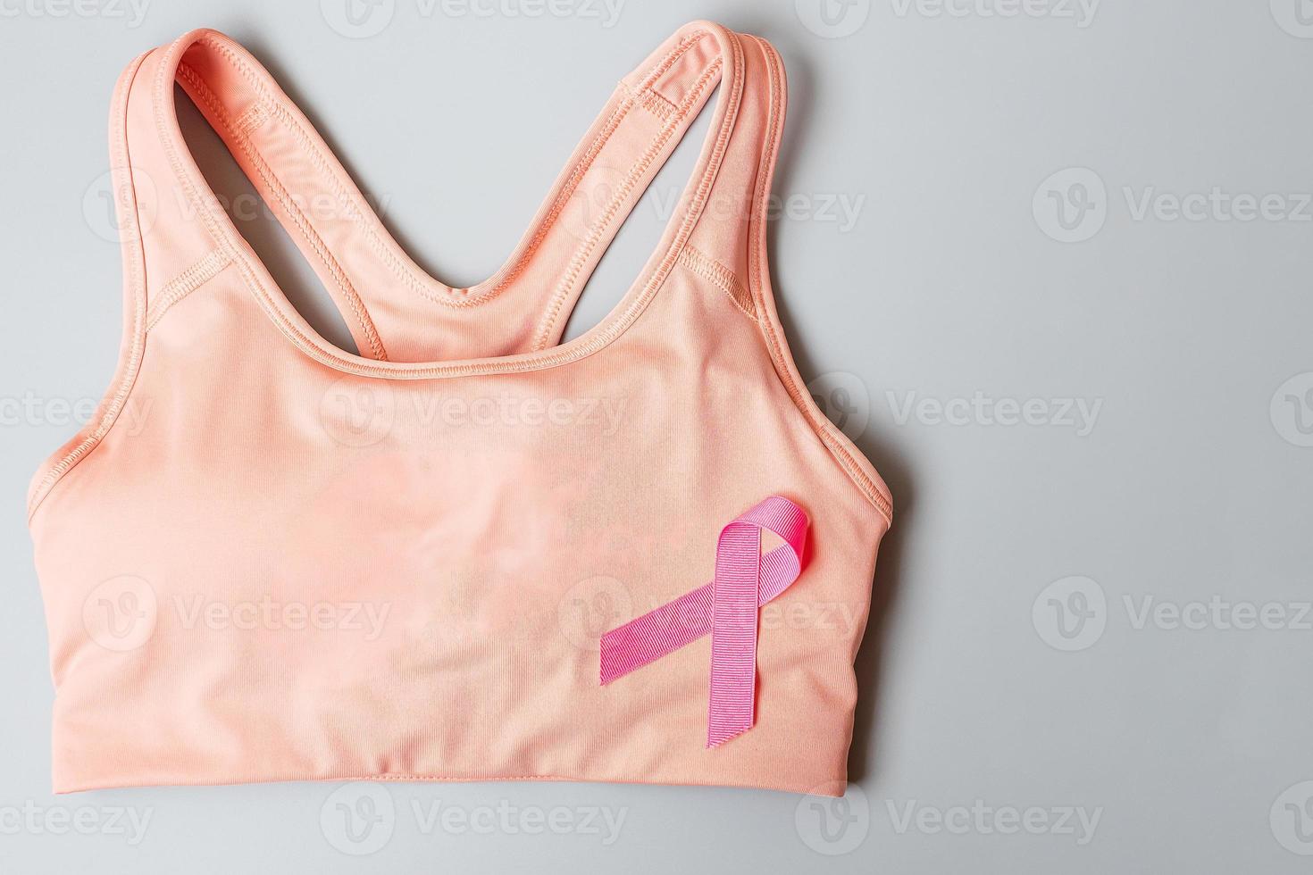 Breast Cancer Awareness month, Pink Ribbon on female sport bar on grey background for supporting people living and illness. Healthcare, International Women day and World cancer day concept photo