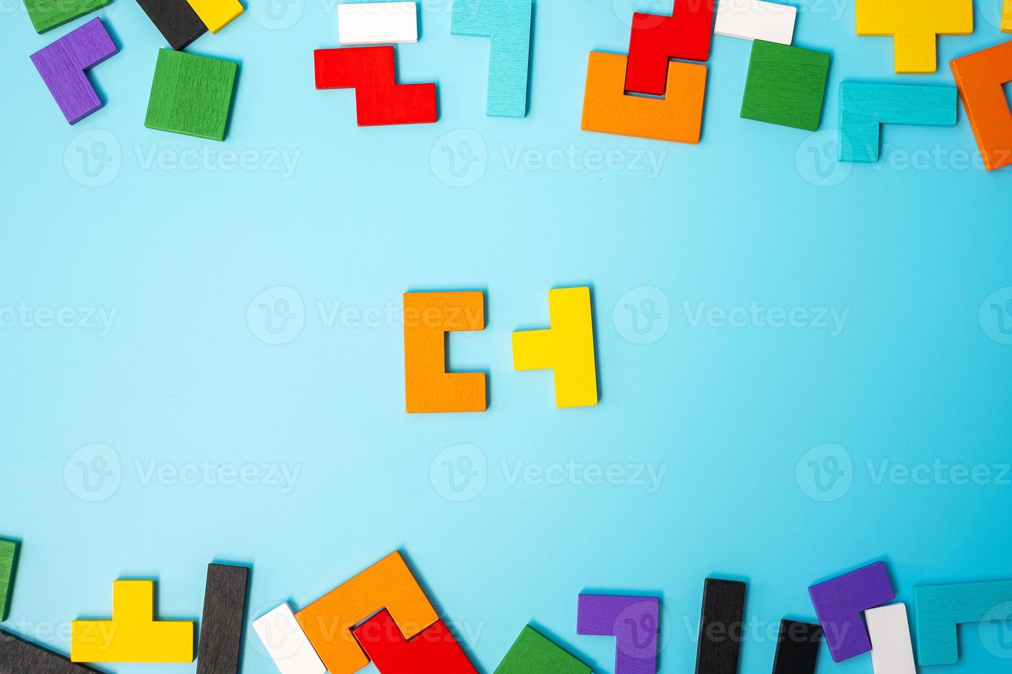 colorful wood puzzle pieces on blue background, geometric shape block. Concepts of logical thinking, Conundrum, solutions, rational, strategy, world logic day and Education photo