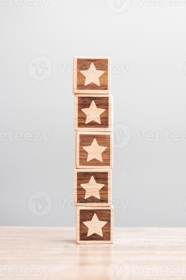 star symbol block on table background. Service rating, ranking, customer review, satisfaction, evaluation and feedback concept photo