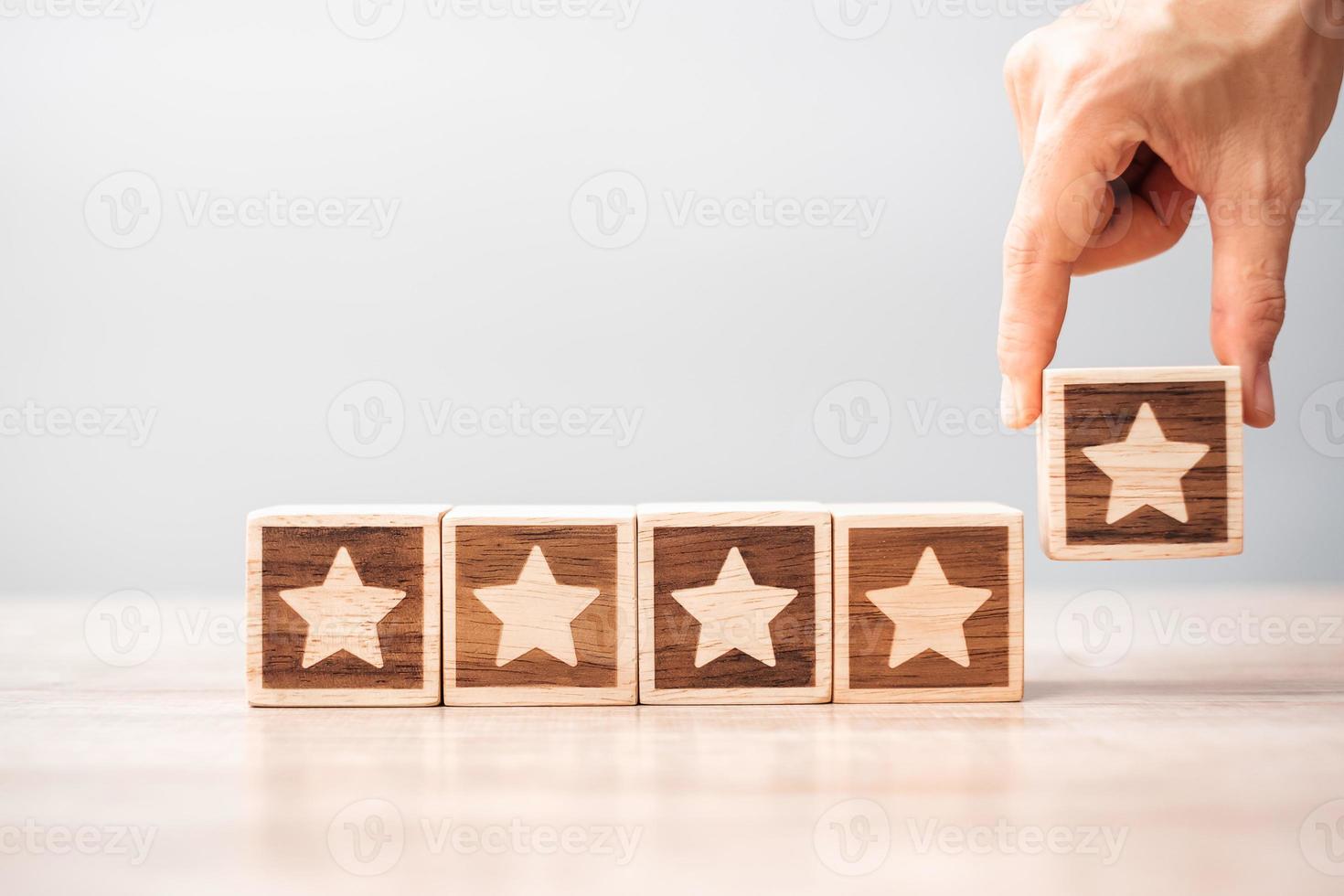 Man hand holding Star block. Customer choose rating for user reviews. Service rating, ranking, customer review, satisfaction, evaluation and feedback concept photo