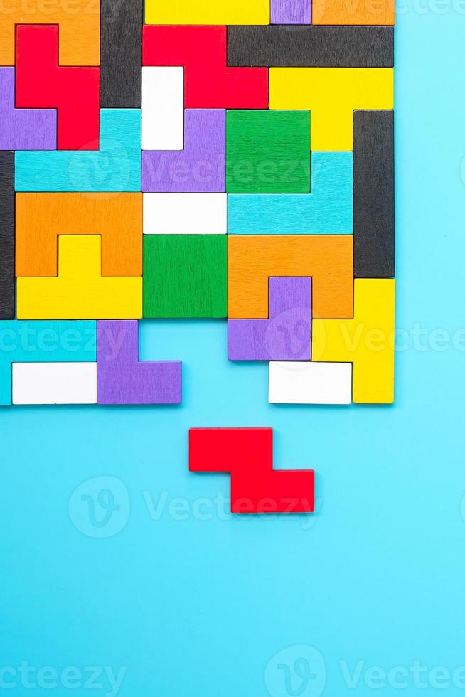 colorful wood puzzle pieces on blue background, geometric shape block. Concepts of logical thinking, Conundrum, solutions, rational, strategy, world logic day and Education photo