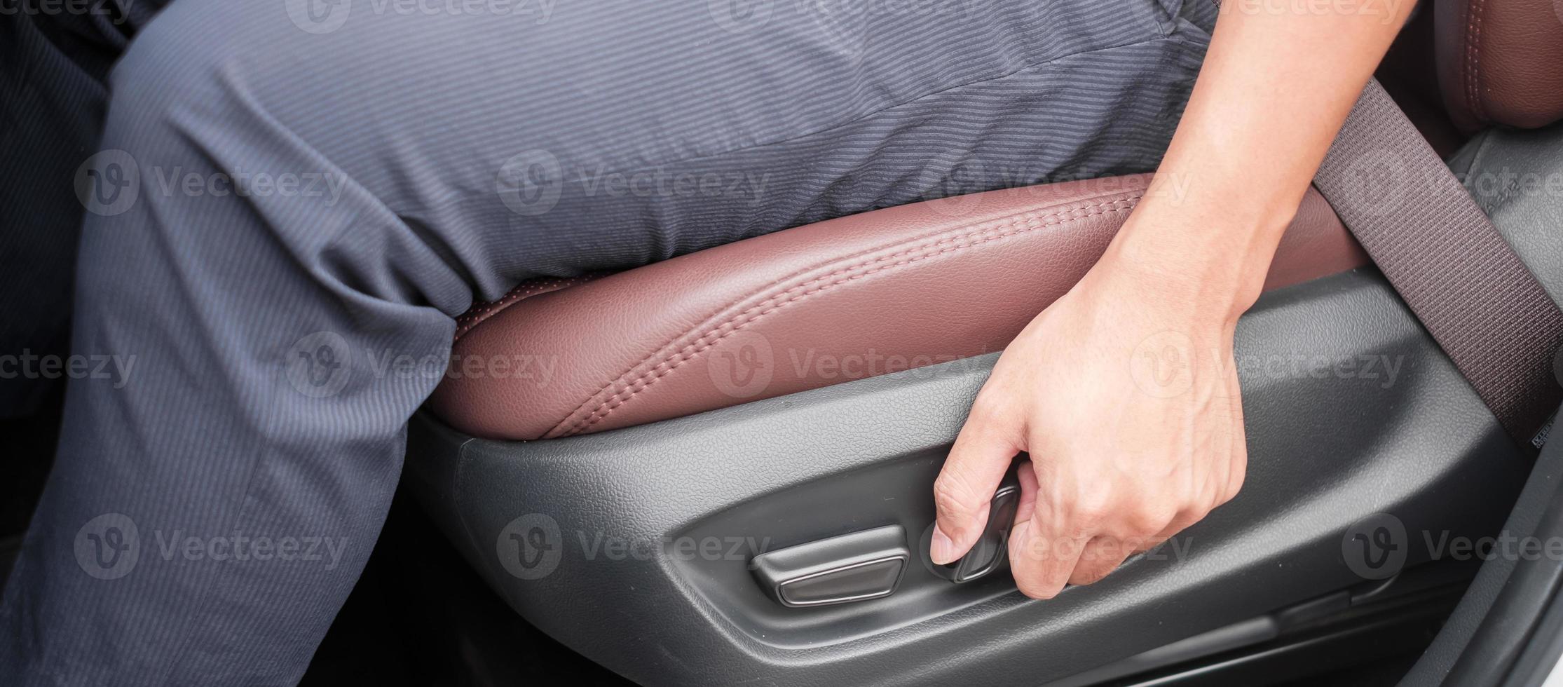 Hand adjust car seat before drive on the road . Ergonomic and safety transportation concept photo