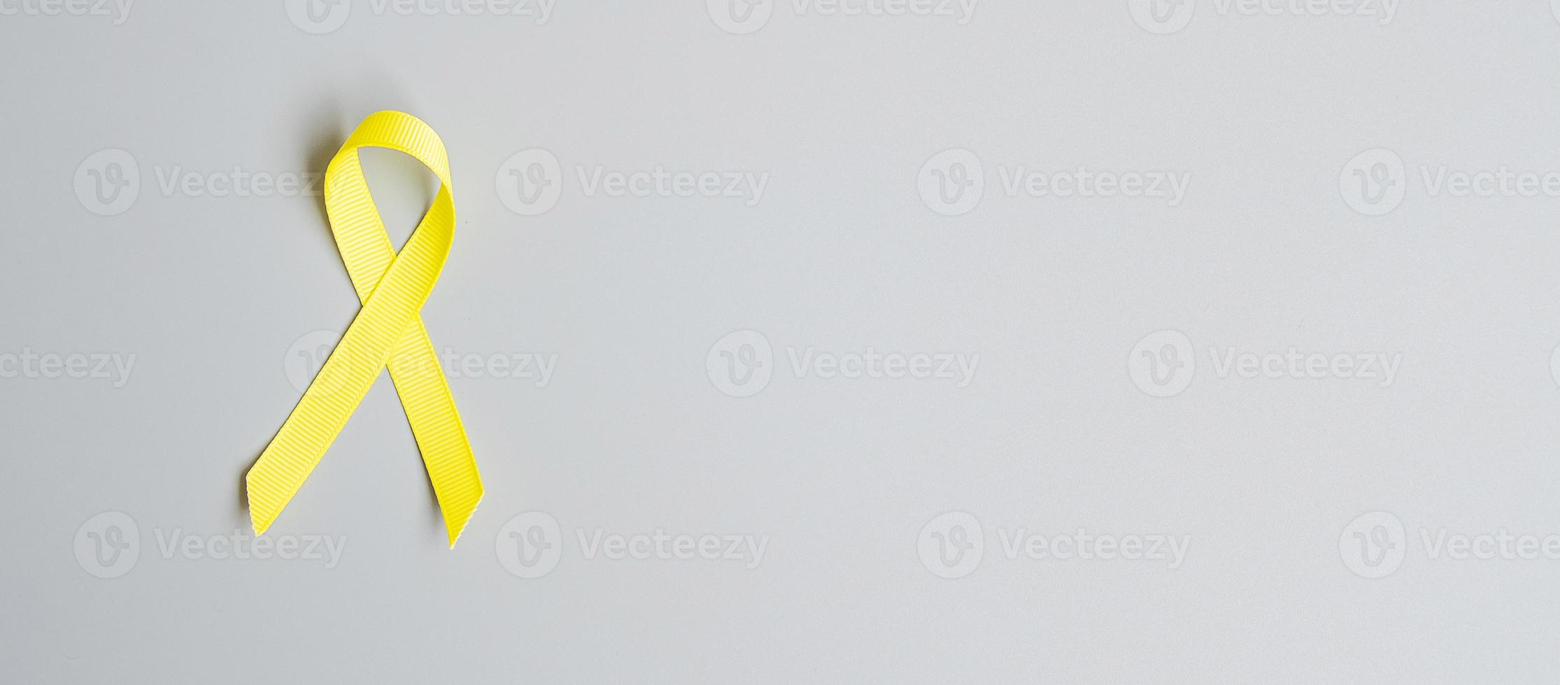 Childhood Cancer, Sarcoma, bone, bladder and Suicide prevention Awareness month, Gold Yellow Ribbon for supporting people living and illness. children Healthcare and World cancer day concept photo