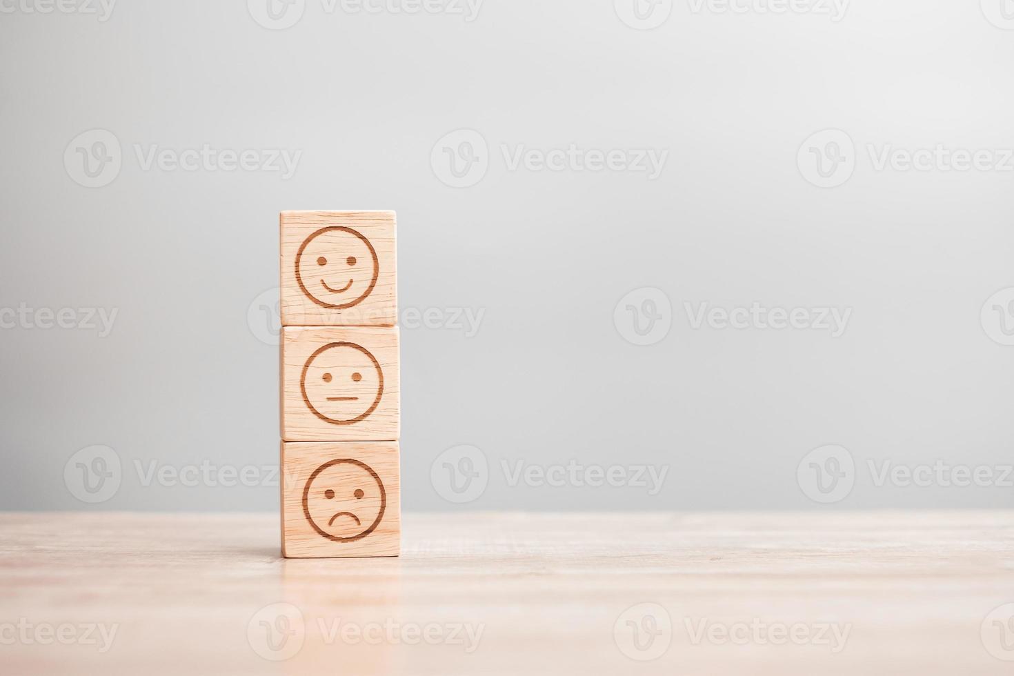 emotion face symbol on wooden blocks. Service rating, ranking, customer review, satisfaction, evaluation and feedback concept photo