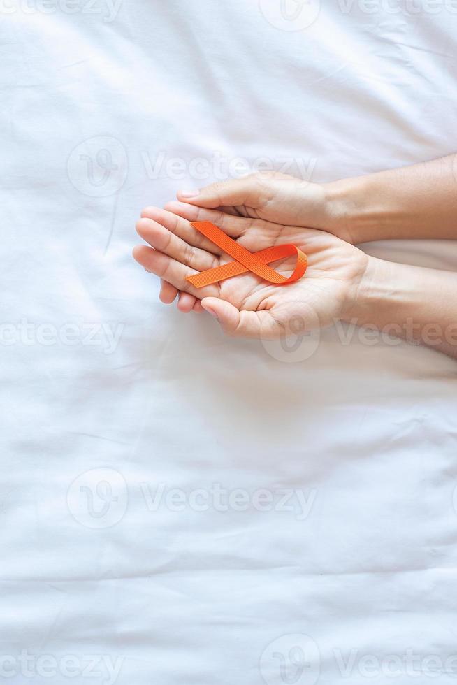 Leukemia, Kidney cancer day, world Multiple Sclerosis, CRPS, Self Injury Awareness month, Orange Ribbon for supporting people living and illness. Healthcare and World cancer day concept photo