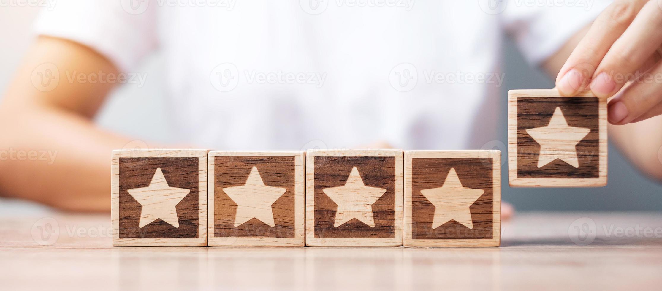 Man hand holding Star block. Customer choose rating for user reviews. Service rating, ranking, customer review, satisfaction, evaluation and feedback concept photo