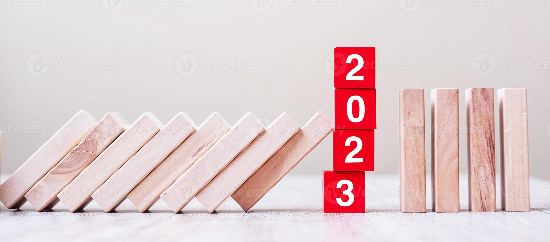 Red 2021 cube blocks stop falling blocks on table. Business, Risk Management, Insurance, Resolution, strategy, solution, goal, New Year planning and  investment concepts photo