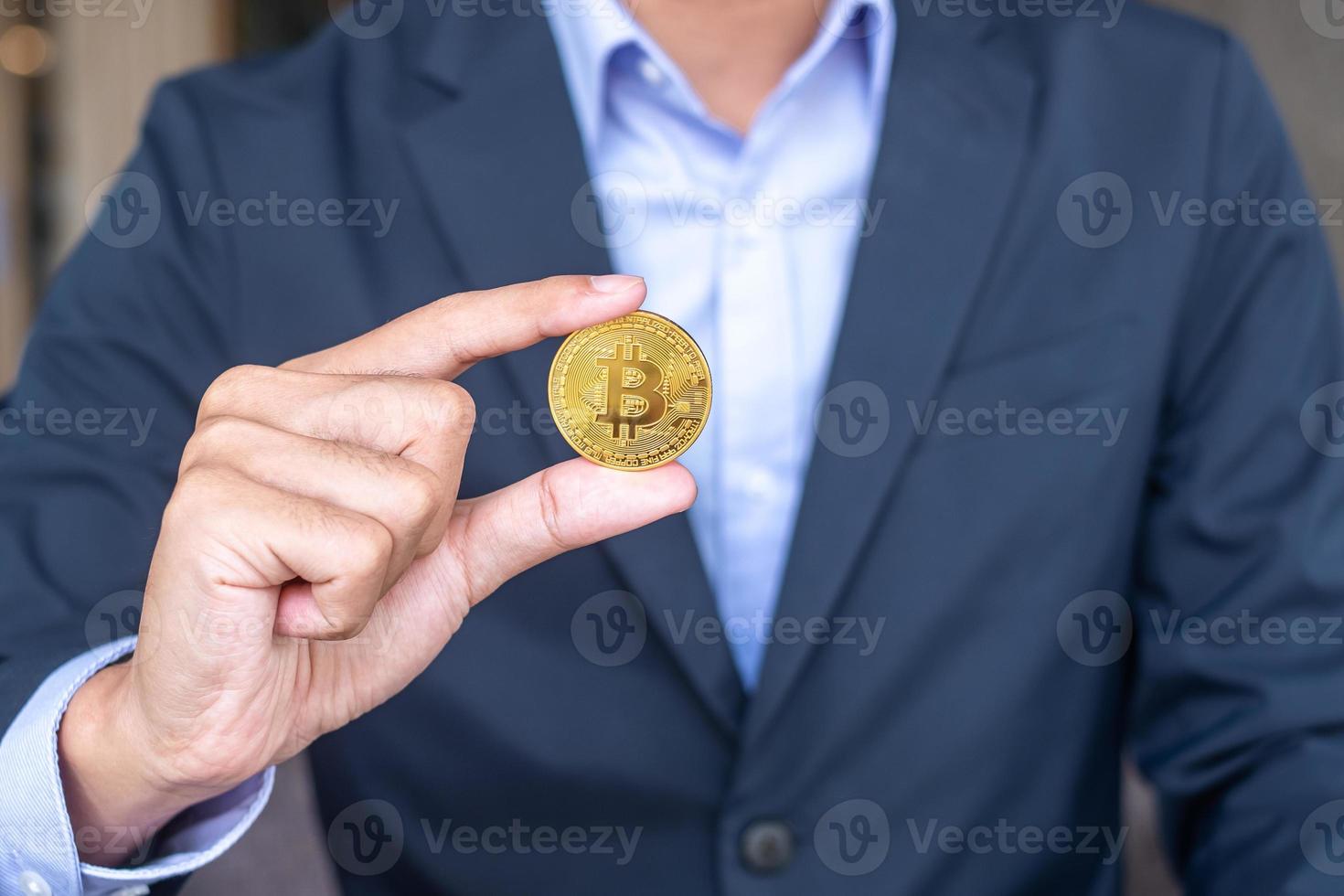Businessman hand holding golden Bitcoin  cryptocurrency, Crypto is Digital Money within the blockchain network, is exchanged using technology and online internet exchange. Financial concept photo