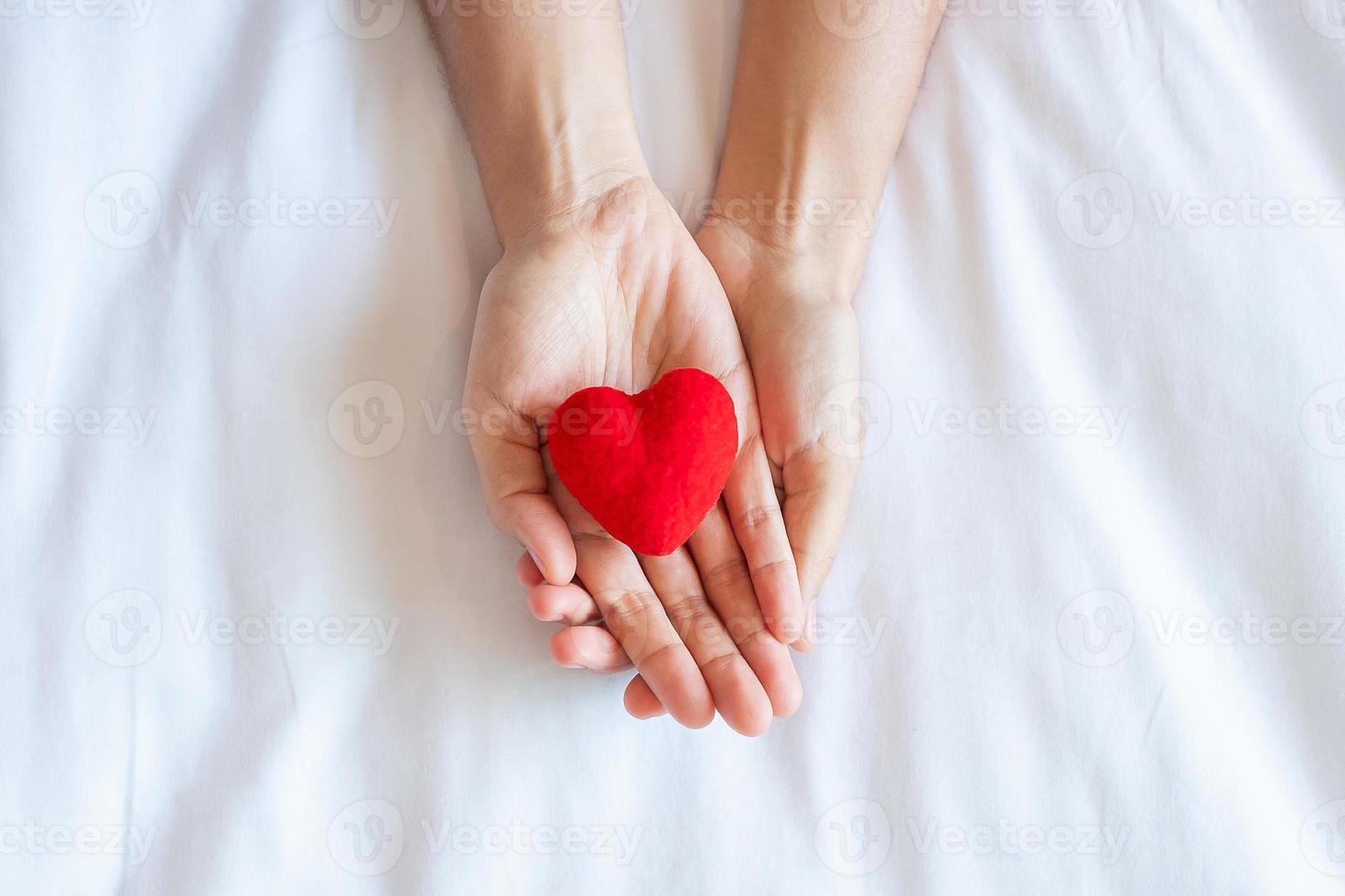 Woman holding Red heart shape on white background. Healthcare, life Insurance, donation, health and World Heart Day concept photo