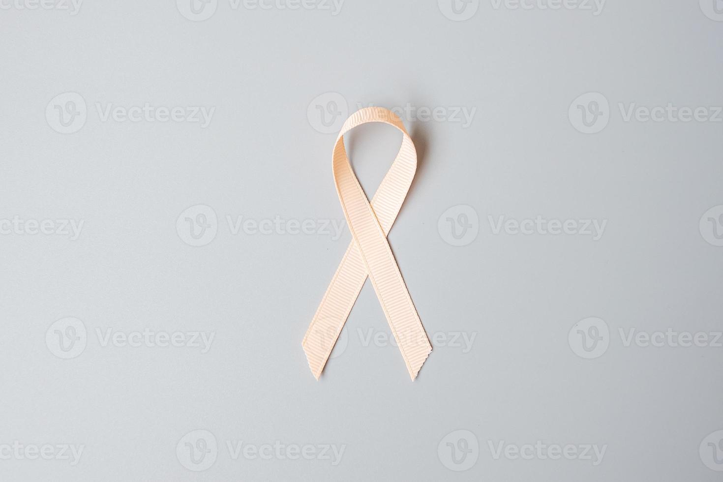 September Uterine Cancer Awareness month, Peach Ribbon for supporting people living and illness. Healthcare and World cancer day concept photo