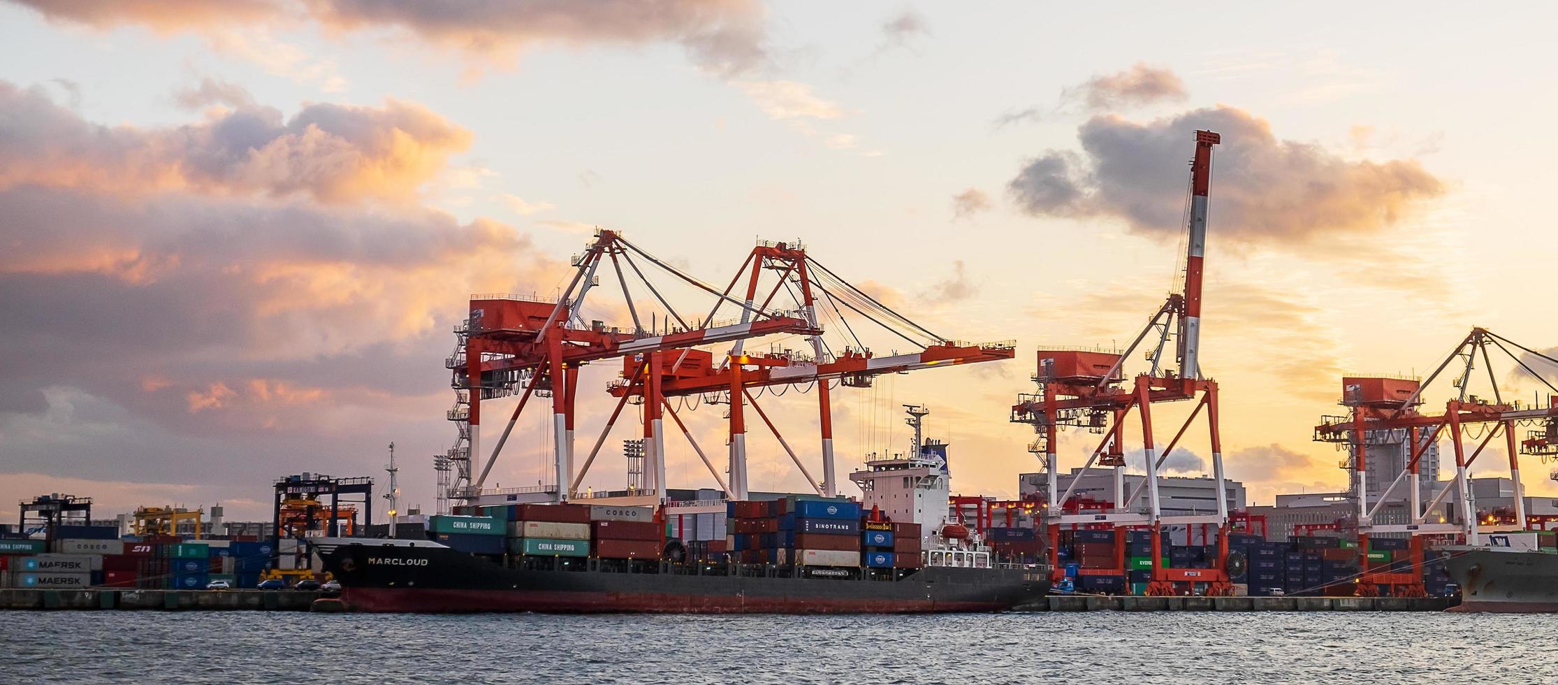 working crane and container Cargo ship of Logistics and transportation industry in Osaka city. Osaka, Kansai, Japan, 28 November 2019 photo