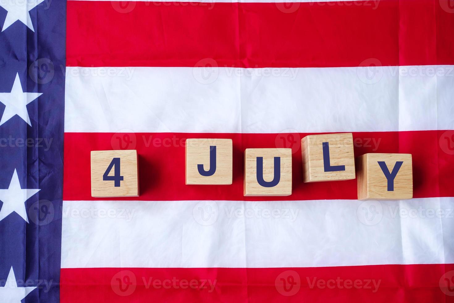 Fourth of July text on United States of America flag background. USA holiday of Independence and celebration concepts photo