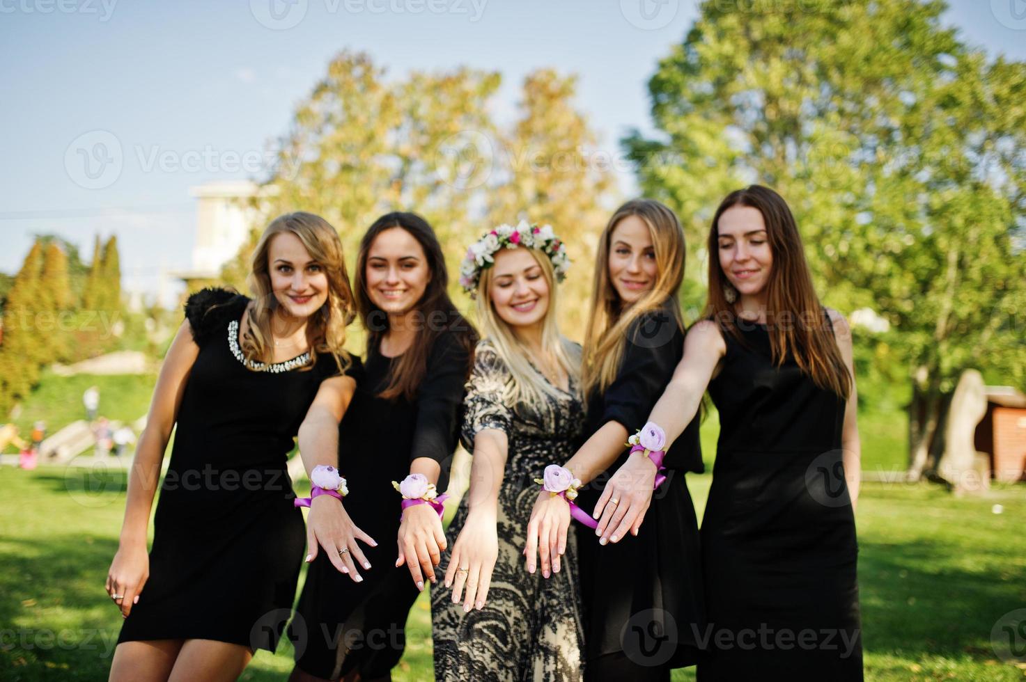 Five girls wear on black having fun at hen party. photo