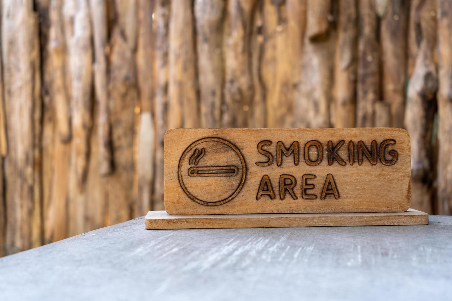 zona de no fumadores cartel de madera colocado sobre una mesa de cemento foto