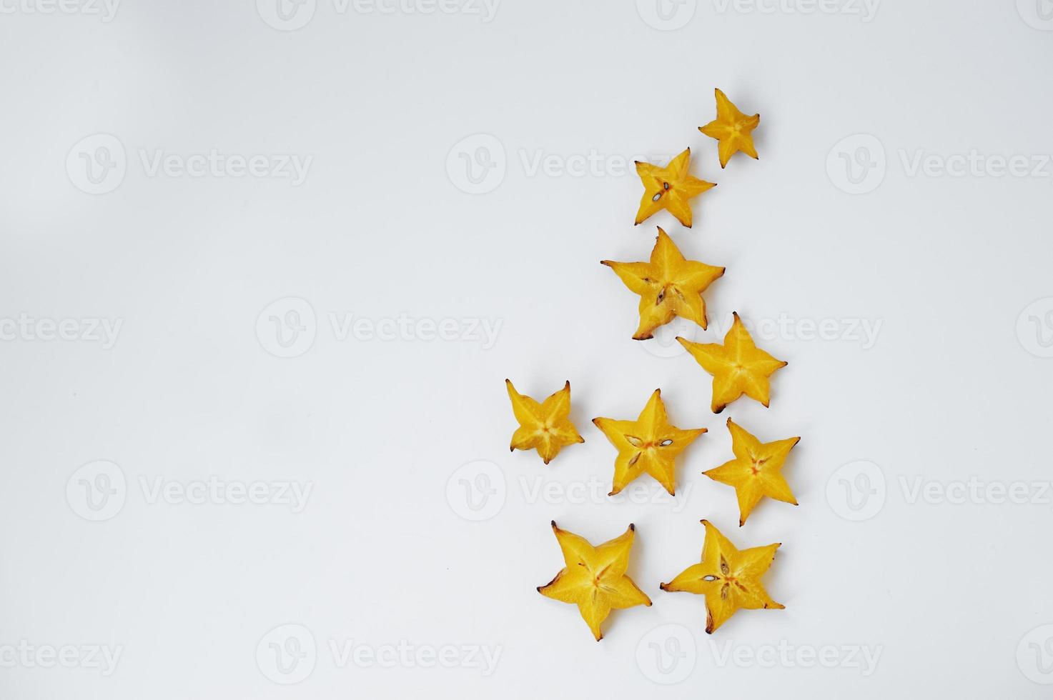 Close-up photo of star fruit or carambola slices on the white background.