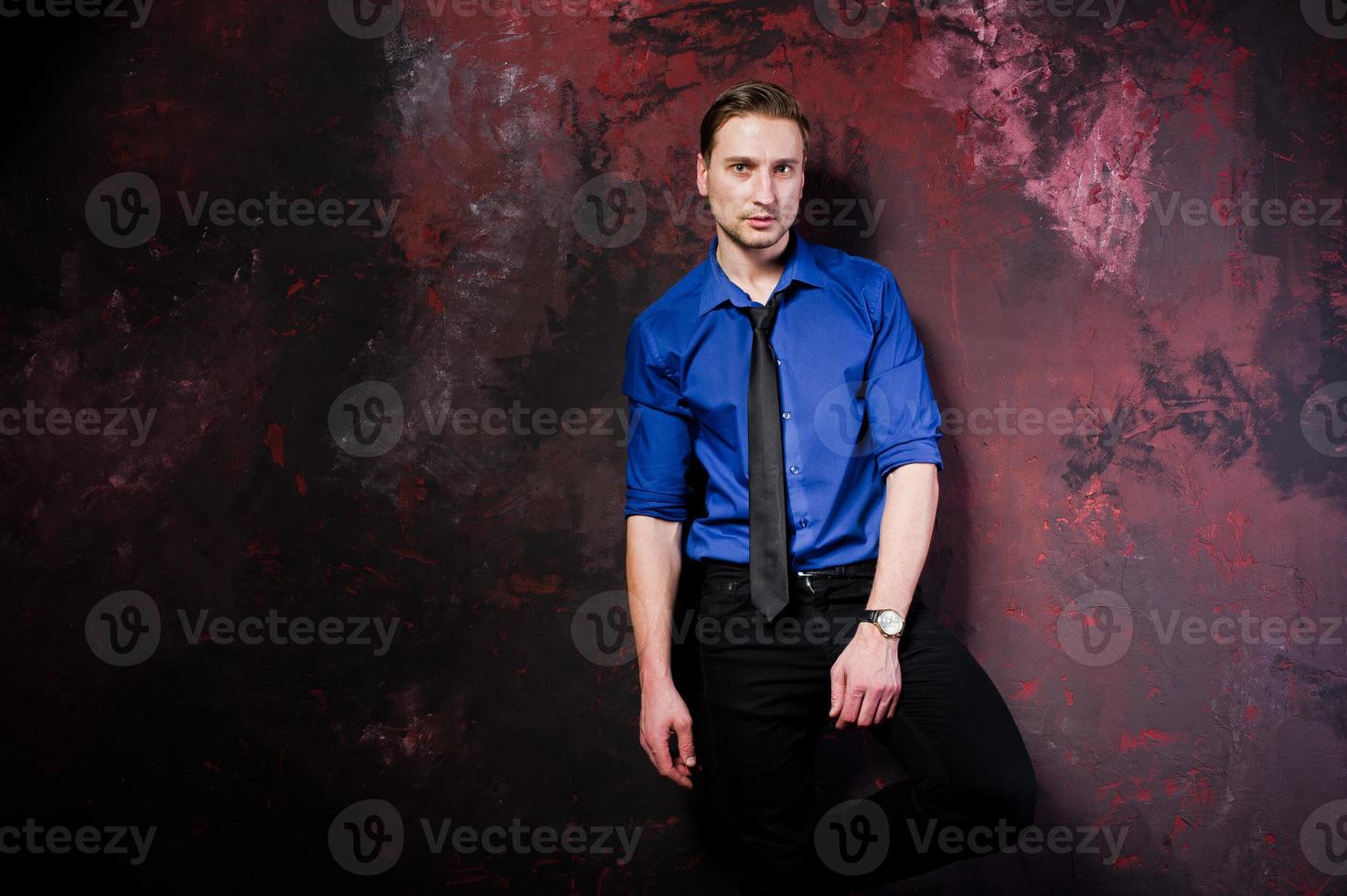 Studio portrait of stylish man, wear on blue shirt and necktie. photo
