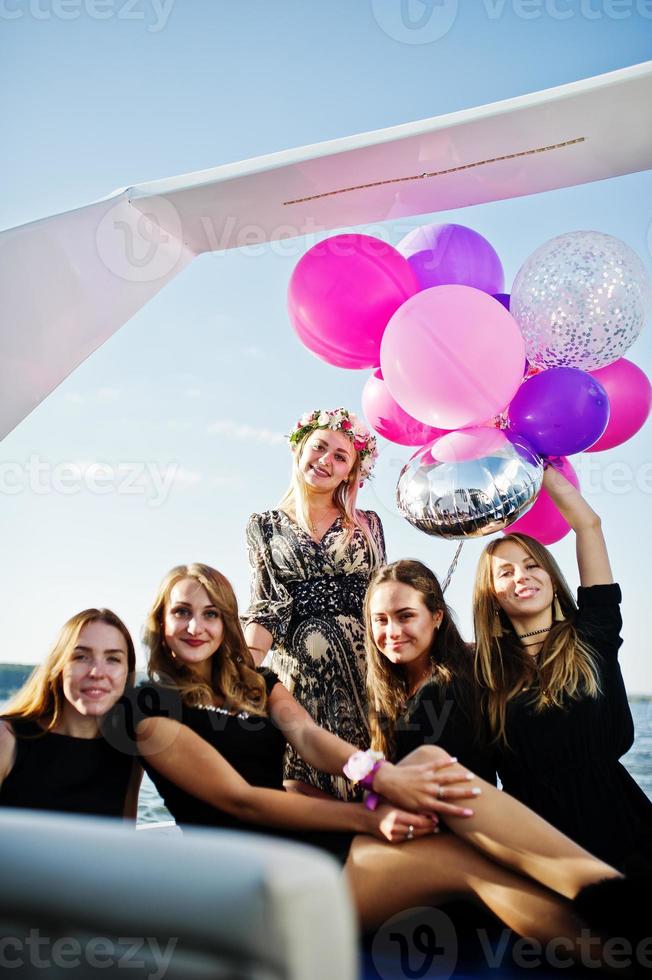 Girls having fun at yacht on hen party. photo