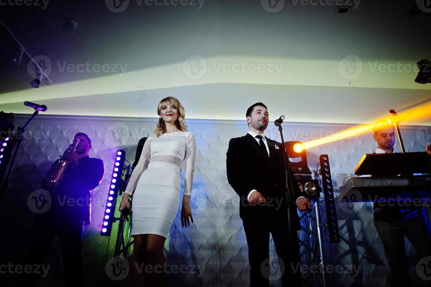 Musicial music live band performing on a stage with different lights. photo