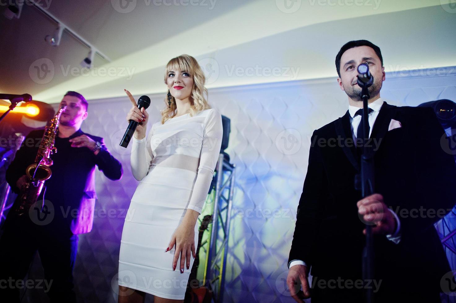 Musicial music live band performing on a stage with different lights. photo
