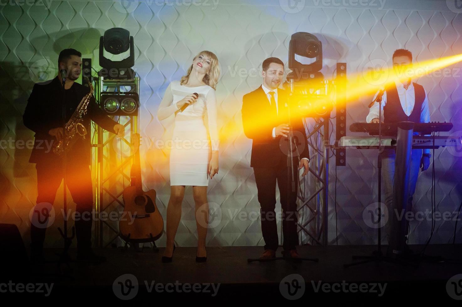 Musicial music live band performing on a stage with different lights. photo