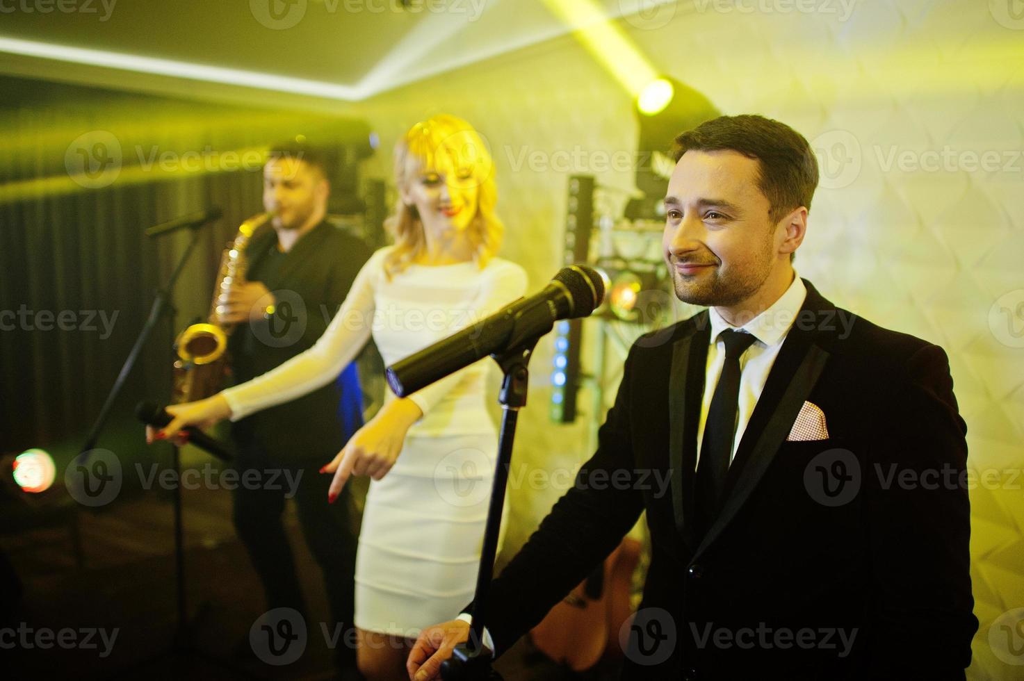 Musicial music live band performing on a stage with different lights. photo