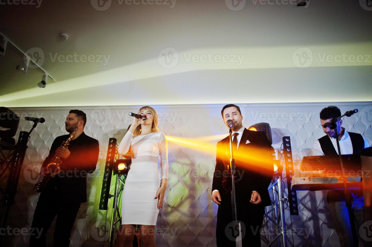 Musicial music live band performing on a stage with different lights. photo