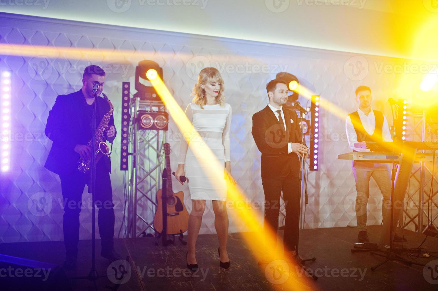 Musicial music live band performing on a stage with different lights. photo